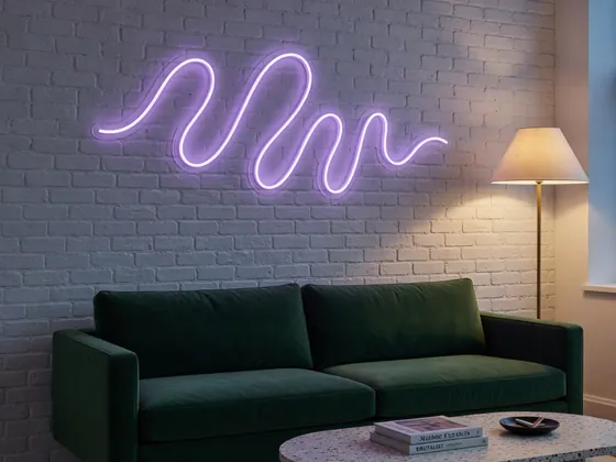 Custom neon in a purple wavy line above a living room sofa